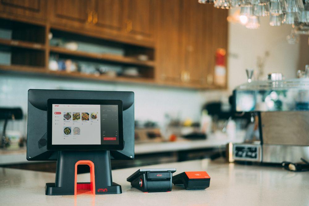 Cashless point-of-sale terminal and card reader on a café counter