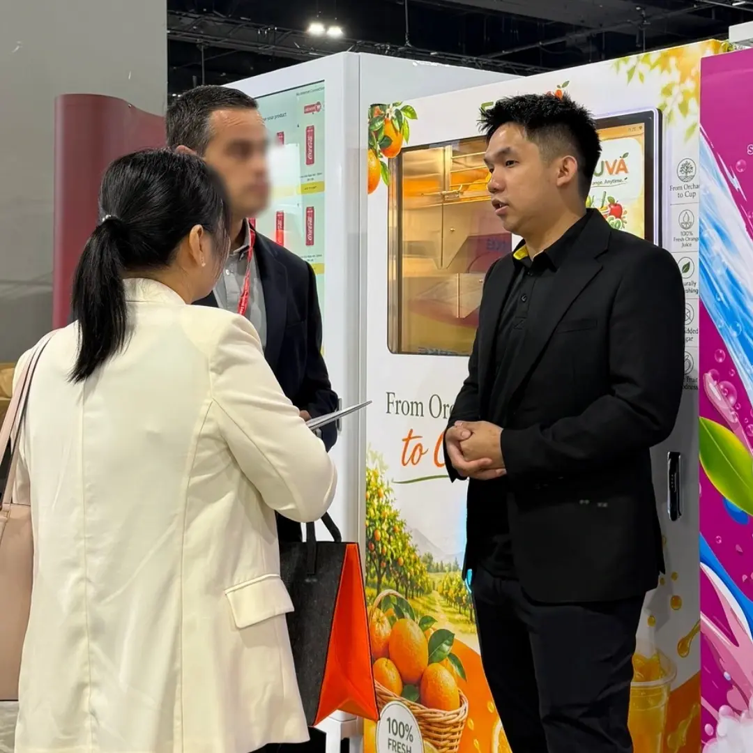 Prosper Peace representative discussing vending solutions with visitors