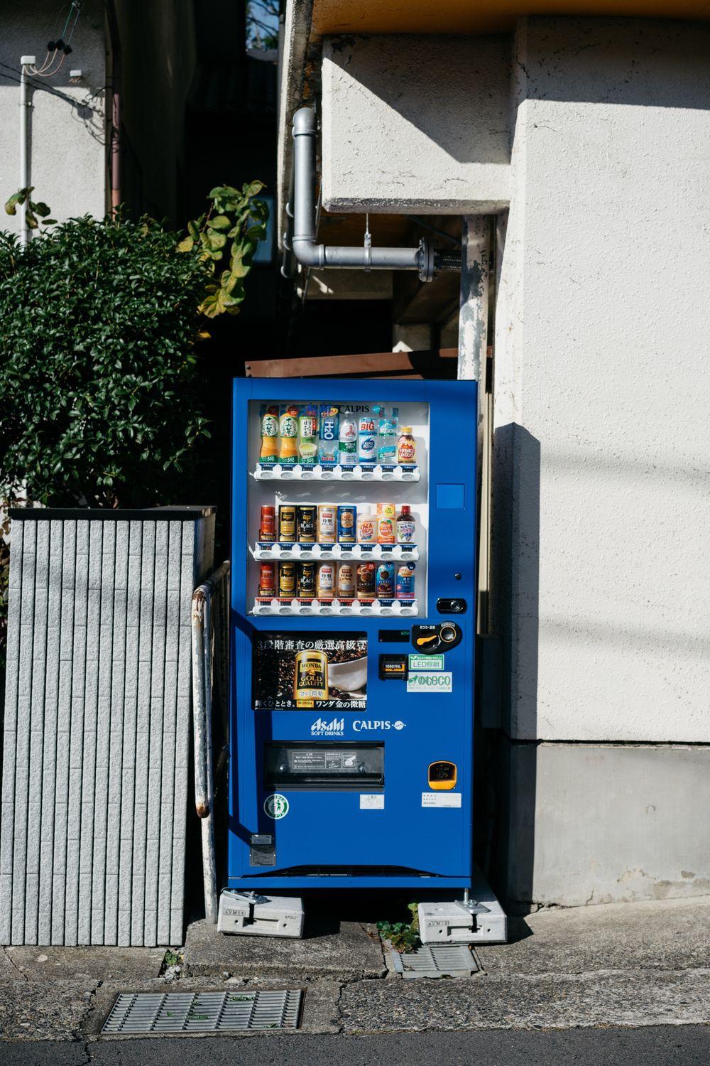 Blue combo vending machine stocked with drinks and snacks